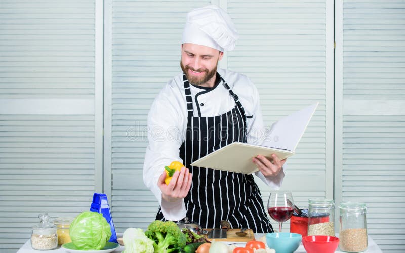 Beginner cook reading recipe book and preparing ingredients.