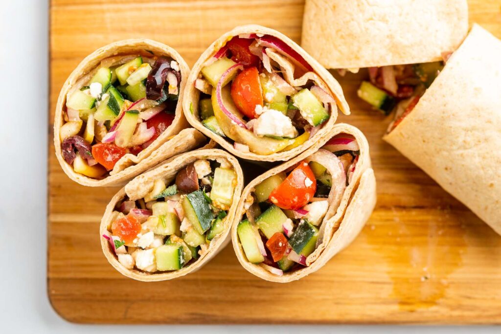 Personalized healthy lunch idea with salad and wrap prepared for work.