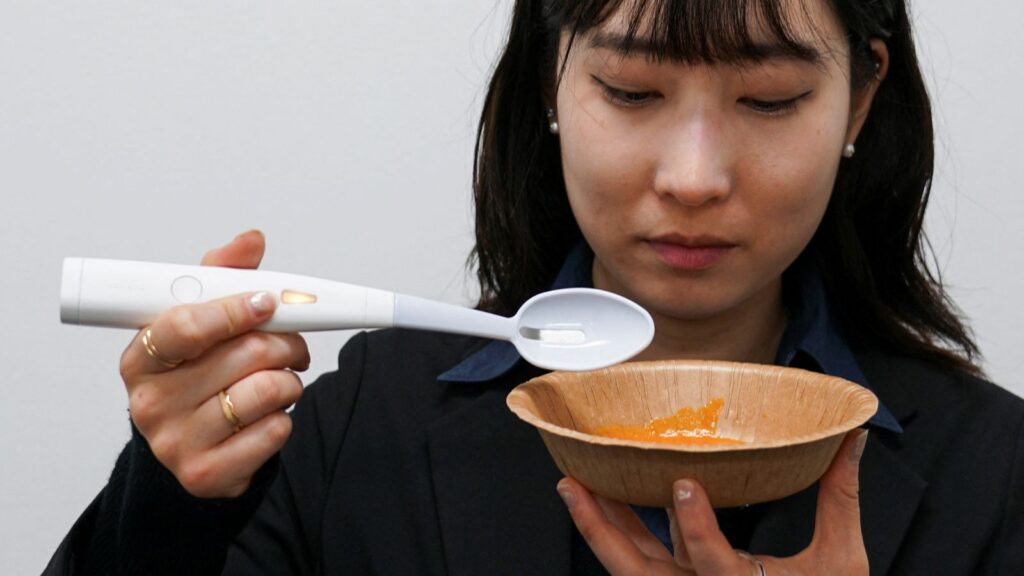 User testing electric salt spoon gadget for soups and curries