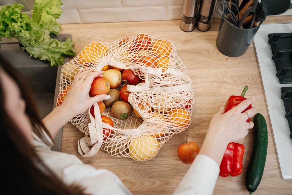 Vegetables like potatoes, onions, and garlic stored at room temperature.