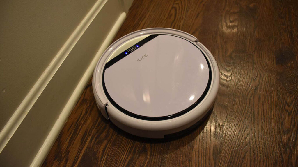 iLife V3s Pro affordable robot vacuum cleaning crumbs and pet hair in kitchen